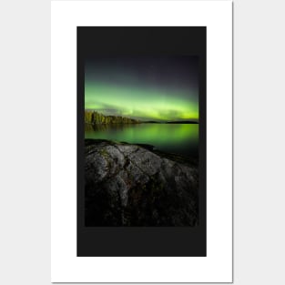 Northern lights glowing over lake in Finland Posters and Art